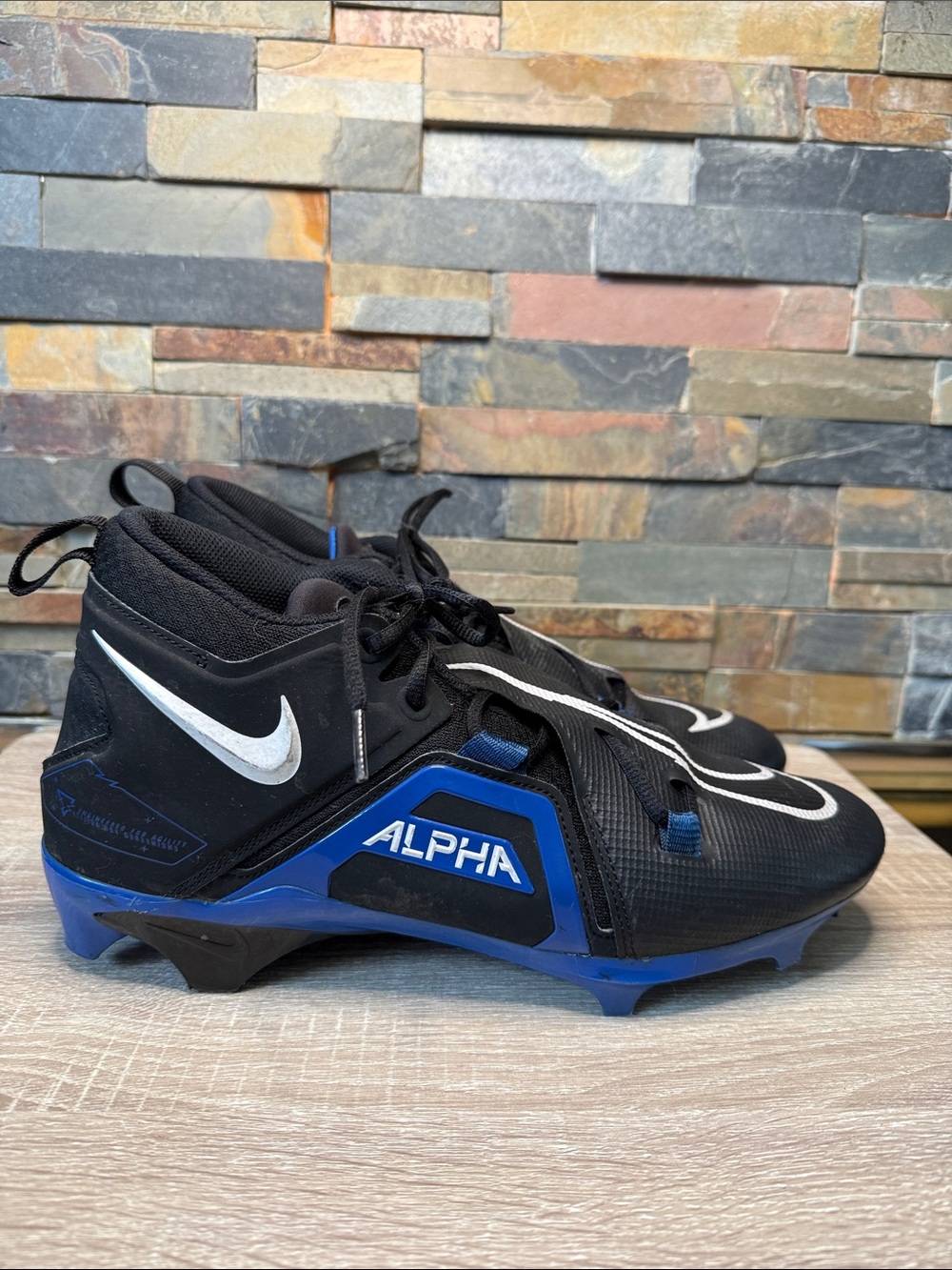 Nike Alpha Menace Pro 3 football cleats in a black and game royal blue